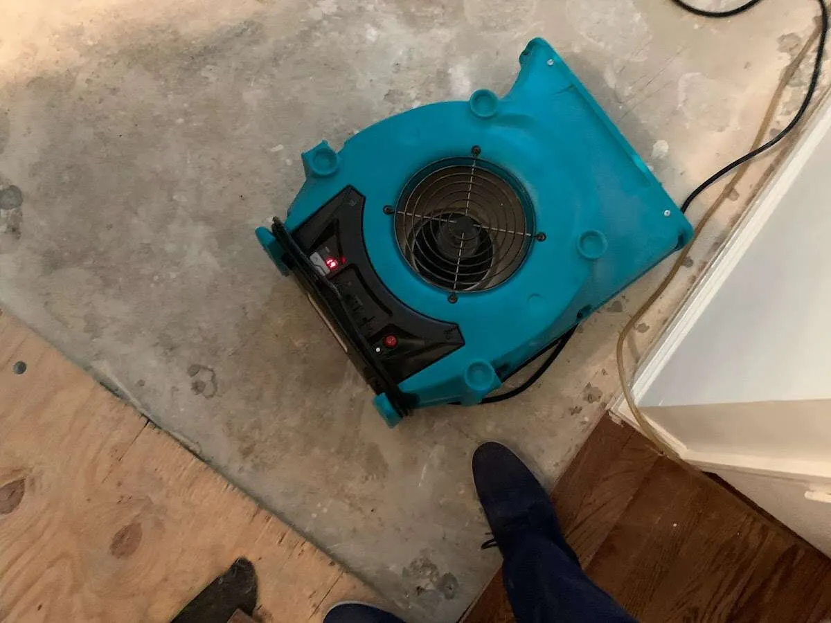 Air mover drying subfloor during Commercial Water Damage Restoration in North College Hill